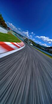 A racing track with a blue sky and a red stripe photo