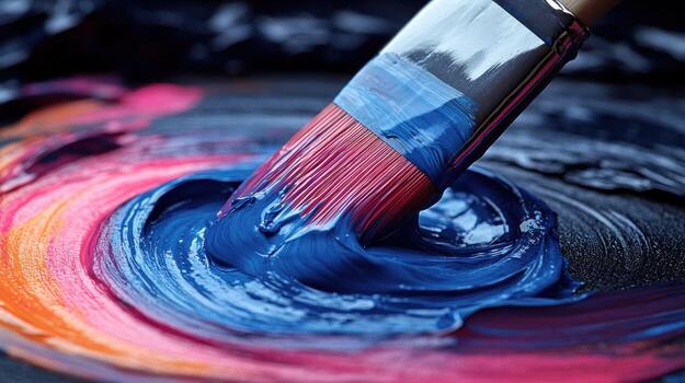 A paintbrush blends bright colors on textured surfaces, making vibrant patterns photo
