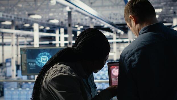 Server hub software developer seeing critical error popup on laptop display, fixing system issues. Data center IT expert gets warning on notebook about hardware problems affecting rigs, camera B photo