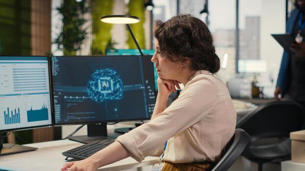 Female employee being pleased with AI integration success for efficiency recognition, using a synergy of data sharing and optimization models in a co working space. Progress prosperity. Camera B. photo