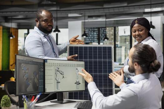 Engineering team doing brainstorming to optimize sustainable solar panel fabrication with advanced assembly lines. Teamworking colleagues innovate clean solar energy manufacturing processes photo