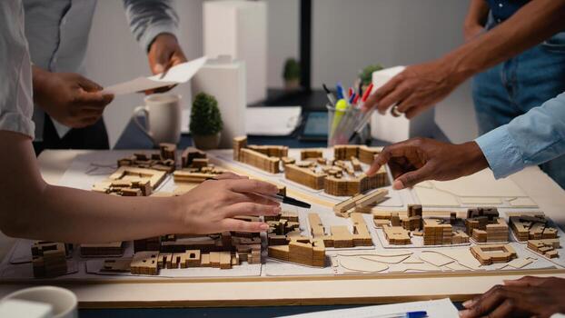 Close up of engineers team creating the property layout for site preparation, using 3D models for urban development and construction project. Infrastructure growth and city planning. photo