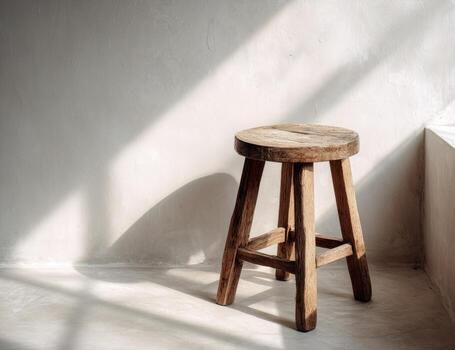 A stool sitting in front of a window photo