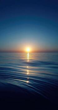 The sun is setting over the ocean photo