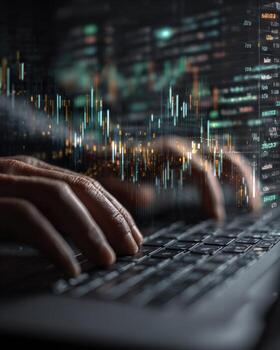 Man typing on laptop with stock market graph photo