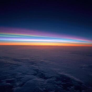 A rainbow is seen from an airplane window photo