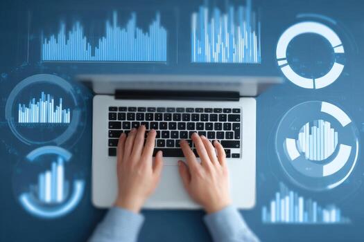 Businessman using laptop with graphs and charts on background photo