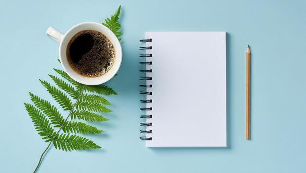 Notebook, coffee and fern leaf on blue background photo