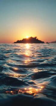 Sunset over the sea with waves and a small island photo