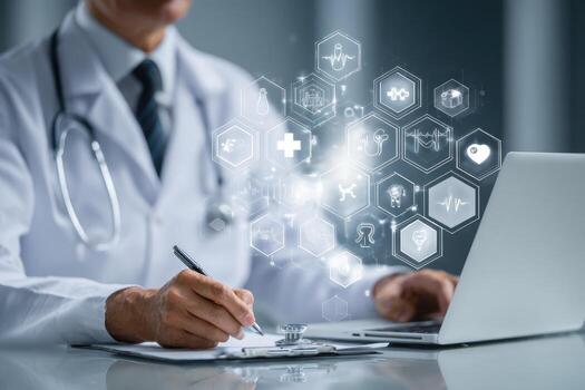 A doctor is working on his laptop with icons on the screen photo