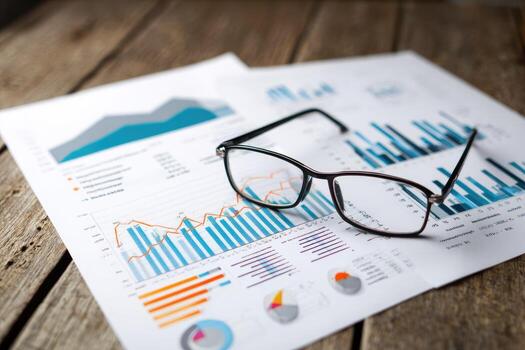 Glasses and business charts on a table photo