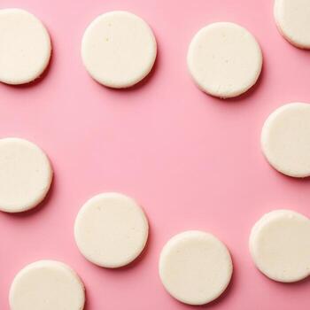 White cookies on pink background photo