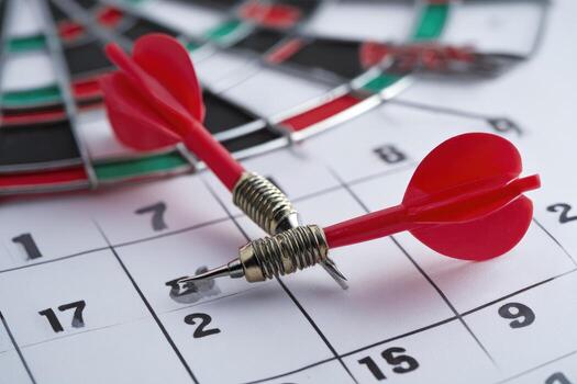Two darts are placed on a dart board photo