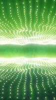 Abstract glowing green light waves with luminous dotted patterns forming a futuristic background video