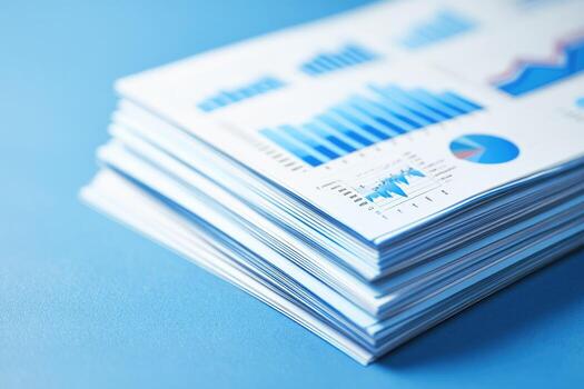 A stack of papers with graphs and charts on them photo