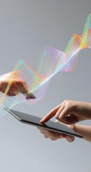 Hands touching a tablet with colorful waves photo