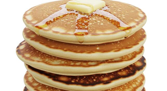 Stack of pancakes with butter and syrup, isolated on white photo