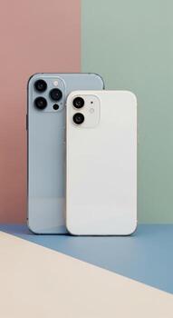 Two Modern iPhones Showcasing Different Models on a Pastel Background. photo