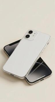 Two iPhones stacked on a neutral surface. photo