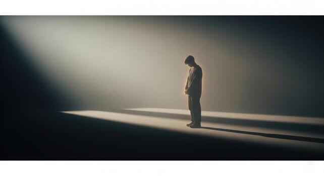 Man in Spotlight Contemplative and Alone. photo