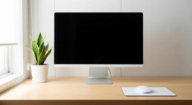 Modern Workspace with Computer and Plant. photo