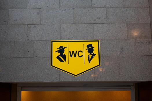 Sign indicating access to men and women restroom. WC with distinctive gender specific symbols. Ideal for public spaces, ensuring easy identification and gender inclusive access to facilities photo
