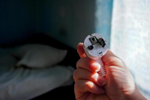 Detailed view of severely melted electrical plug components showing thermal failure patterns. Essential for engineering failure analysis and safety research documentation. photo