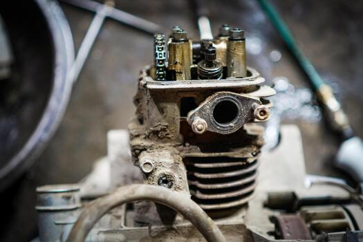 Close-Up of an Old Motorcycle Engine Component in a Workshop Setting photo
