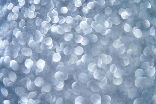 Abstract silver bokeh background with defocused circular light patterns creating a dreamy and ethereal visual effect. photo