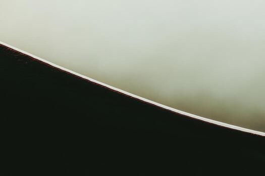Close-up view of dark and light curved surfaces in abstract composition photo