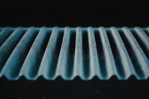 Detailed view of a textured surface with ridges showing light and shadows photo