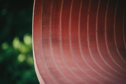 Curved abstract structure with warm tones set against a lush background photo