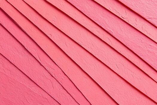 Textured pink paper strips arranged in overlapping layers on a surface photo