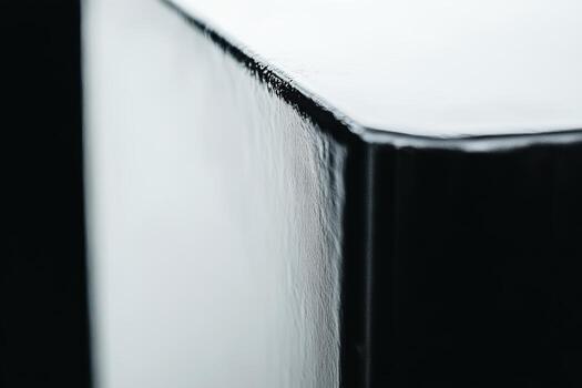Close-up view of a glossy black surface highlighting texture and shine photo