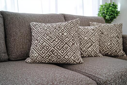 Cozy living room setup with patterned cushions and soft textiles photo