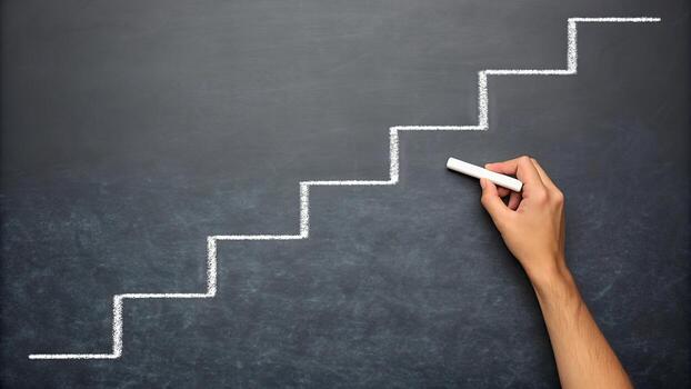 Hand drawing a staircase with chalk on a dark blackboard representing progress photo