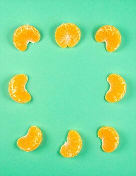 Citrus Fruit Slices Arranged in a Circular Pattern on Bright Turquoise Background with Soft Shadow photo