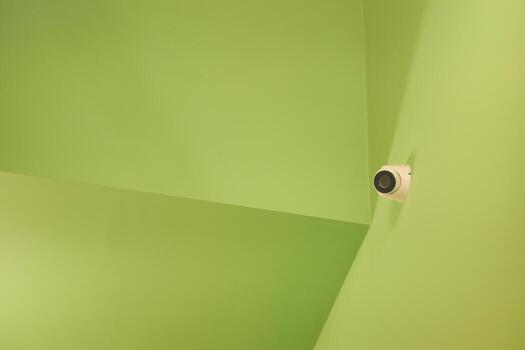 Green angular walls with a security camera in the corner photo