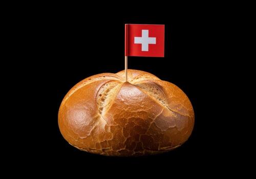 Golden bread roll topped with a swiss flag on black background photo