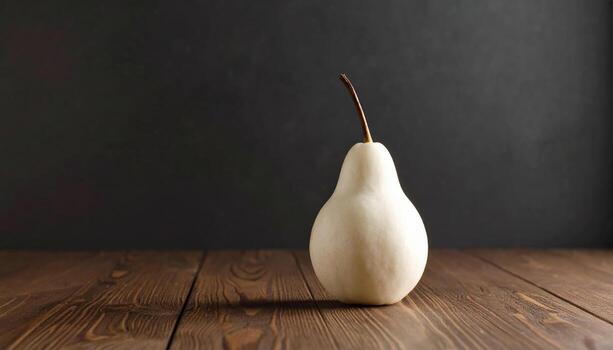 Pristine white pear with smooth skin rests elegantly on rustic wooden table, contrasting beautifully against dark textured background, evoking sense of simplicity and elegance photo
