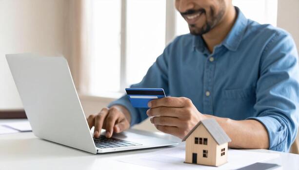 Man using credit card to buy a house photo
