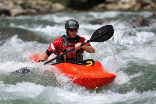Kayaker navigating a river's rapids with determination during a sunny day in summer photo