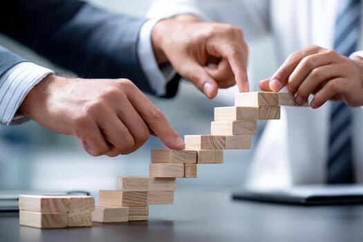 Business professionals collaborating to build a wooden staircase from blocks in a modern office photo
