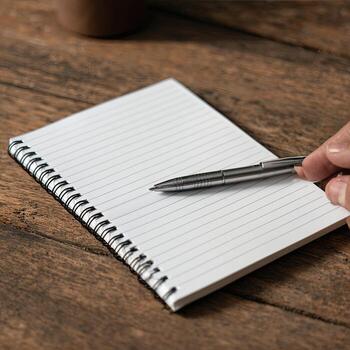 Closeup of blank notepad and pen photo