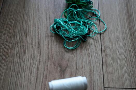 An Array of Colorful Threads and Spools on a Wooden Surface photo