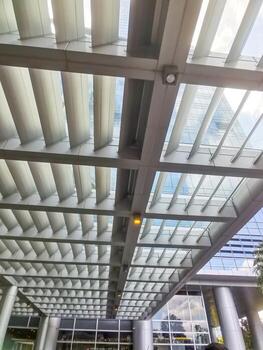 Geometric overhead structure casting shadow patterns, modern architecture and linear design. photo