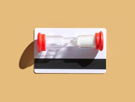 Hourglass timer on cardboard background symbolizing time passing and deadline concepts. photo