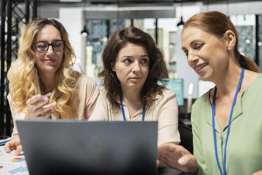 Team of diverse colleagues aligning objectives with data reports, reviewing financial performance data to lead company toward success in a smart and collaborative work environment. photo