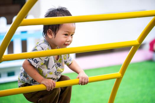 Free play in the playground for baby is important activity for child development. Child can learn and enjoy explore sights and sounds and test her continuously developing skills. photo