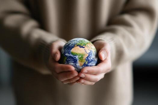 Globe held in hands representing environmental protection and global awareness photo